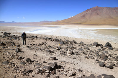 Man standing on land against sky