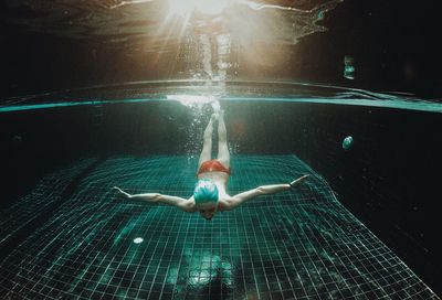 Full length of shirtless boy swimming in pool