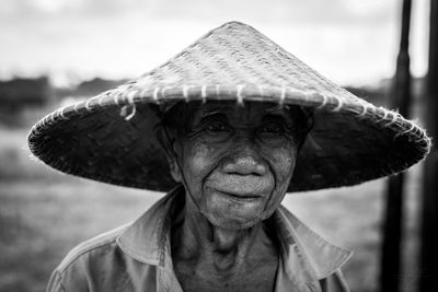 Close-up portrait of senior man wearing hat