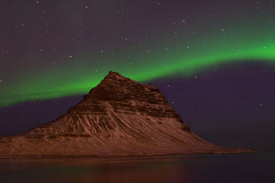 Scenic view of mountain against sky at night