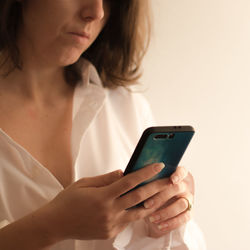 Midsection of woman using mobile phone