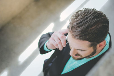 High angle view of businessman talking on mobile phone