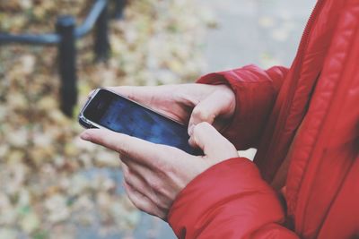 Midsection of man using mobile phone