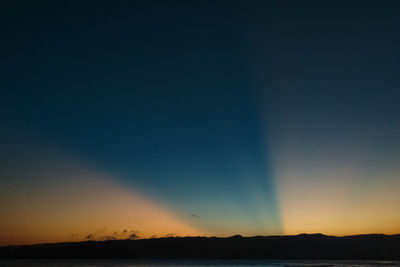 Scenic view of silhouette landscape against clear sky at sunset