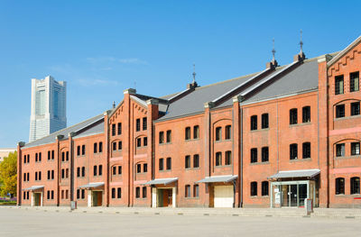 Low angle view of buildings against clear blue sky