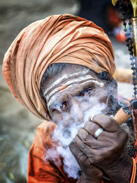 Close-up of man smoking pipe