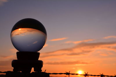 Low angle view of silhouette light against sky during sunset