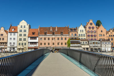 Buildings against clear blue sky in city