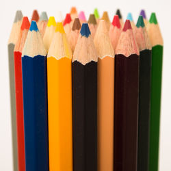 Close-up of colored pencils against white background