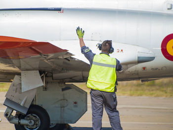 Full length of man working at airplane