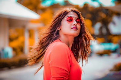 Portrait of beautiful young woman wearing sunglasses