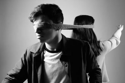 Friends standing against gray background