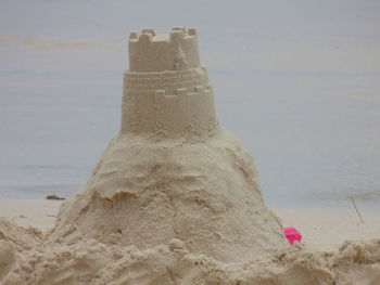Close-up of beach against sky