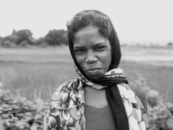 Portrait of woman standing on field