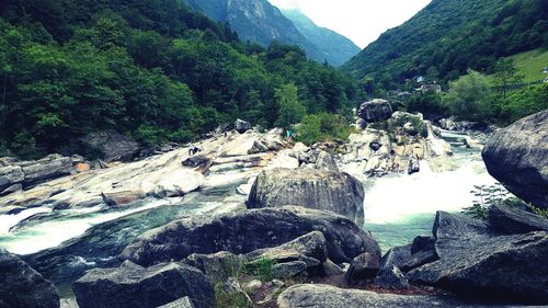 Scenic view of waterfall in mountains