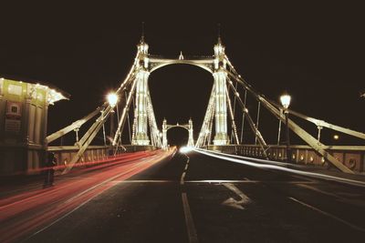 Illuminated bridge at night