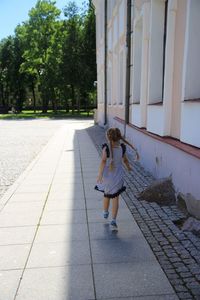 Full length of woman on footpath