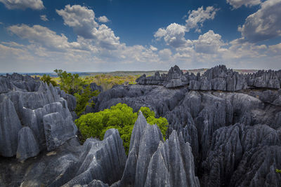 Rock formations on landscape against sky