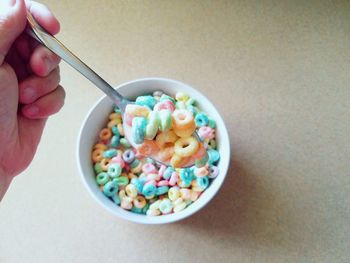 Cropped hand having breakfast cereal