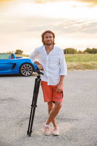 Portrait of young man standing on road