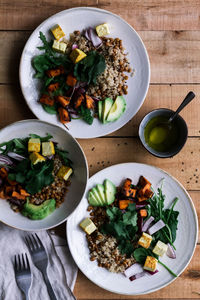 Delicious vegetable dish in plates on table