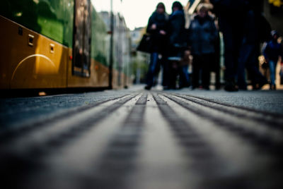 Surface level of people standing by tramway