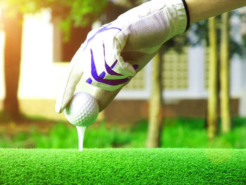 Close-up of person standing on golf course