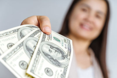 Close-up portrait of woman holding paper