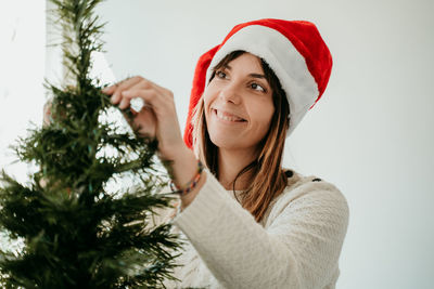 Portrait of woman with christmas tree