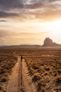 Scenic view of land against sky during sunset