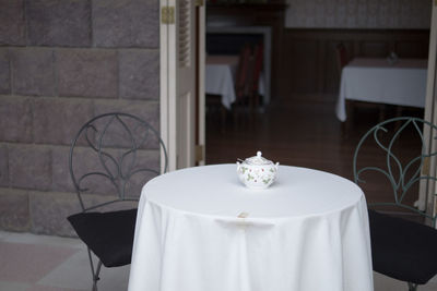 Sugar bowl on white tablecloth