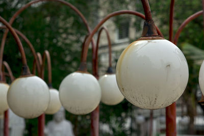 Close-up of old electric lamps hanging outdoors