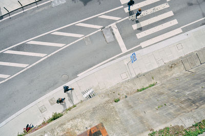 High angle view of people walking on road