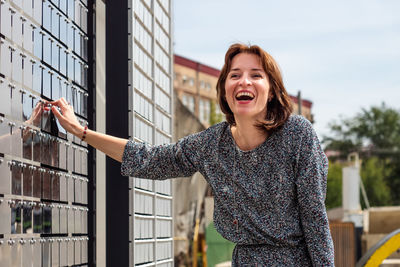 Laughing happy young woman outdoors portrait