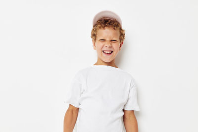 Portrait of smiling boy against white background