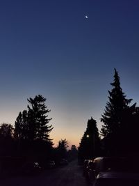 Cars on road against sky at night