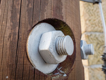 Screw and nut in wooden construction. the detail of the joint on the wooden tower with many screws.