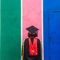 Rear view of person wearing graduation gown