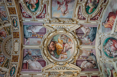 Low angle view of ornate ceiling in temple