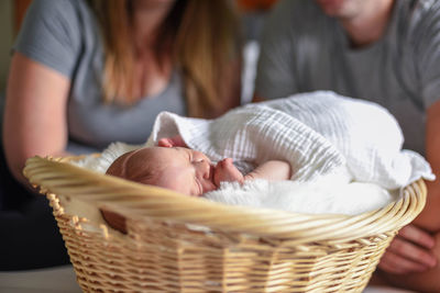 Family sitting on bed at home