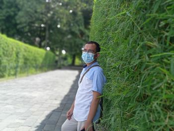 Full length of man walking on footpath