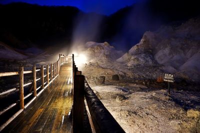 Panoramic view of illuminated mountains against sky