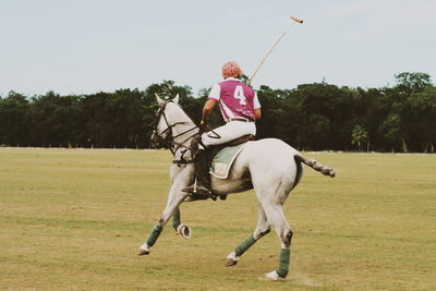 Full length of man playing on field against sky