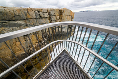 High angle view of steps by sea against sky