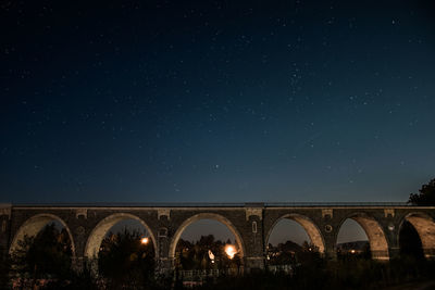 Bridge against sky at night