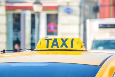 Close-up of yellow taxi sign on car
