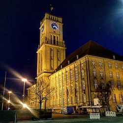 Low angle view of illuminated buildings against sky at night