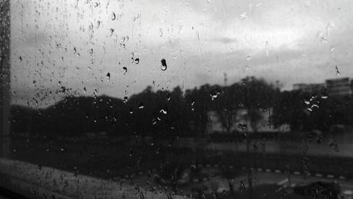 Full frame shot of wet glass window in rainy season