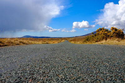 Long road leading up to the mountains in connemara national park