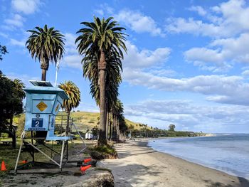 Scenic view of beach against sky with lifeguard stand and palm trees in santa barbara, california 